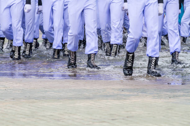 istock Black boots walking on water flooded 878256226