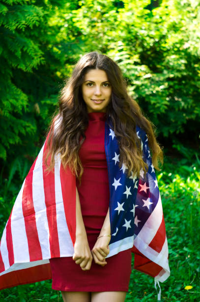 istock girl with a US flag 878256996