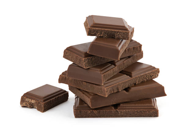 istock Broken black chocolate bars in a heap isolated on white background 878257162