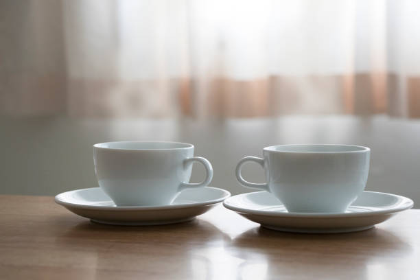 istock Hot coffee two cups breakfast near the curtain windows morning soft light 878262668