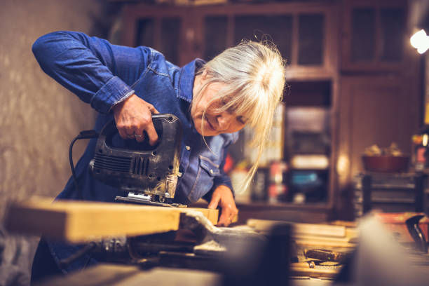 American blue collar worker in a workshop American blue collar worker in a workshop carpenter carpentry craftsperson carving stock pictures, royalty-free photos & images