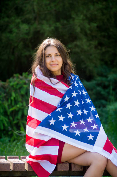 istock girl with a US flag 878265864