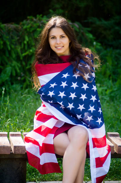 istock girl with a US flag 878265868