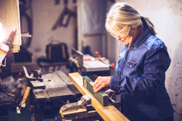 istock Woman in workshop working with wood 878265934