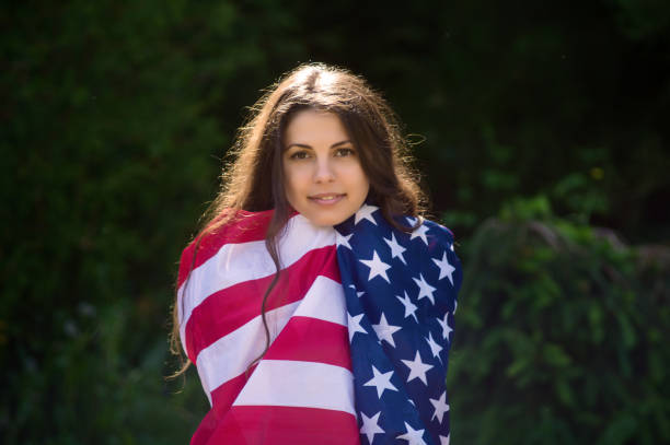 istock girl with a US flag 878266182