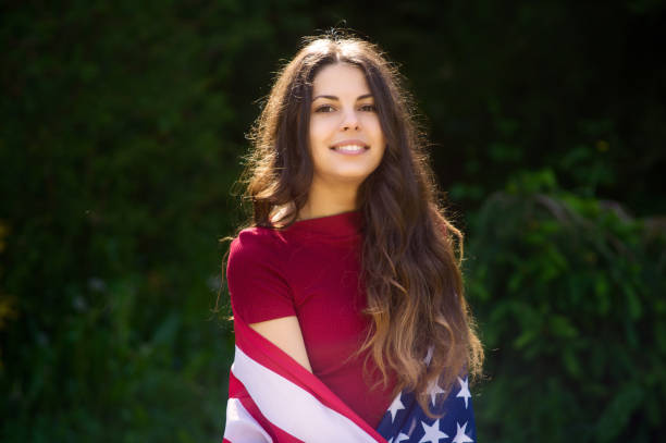 istock girl with a US flag 878268824