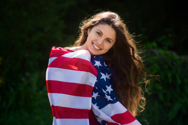 istock girl with a US flag 878268884