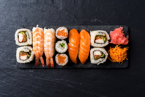 Overhead shot of Japanese sushi on black concrete background