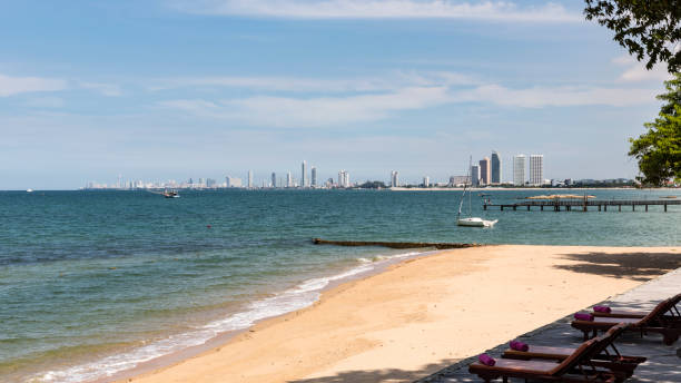istock Clean and clear water in ocean, with white cloud and blue sky as background at skyline, modern builg in the city. Use as holiday and travel concept. 878280838