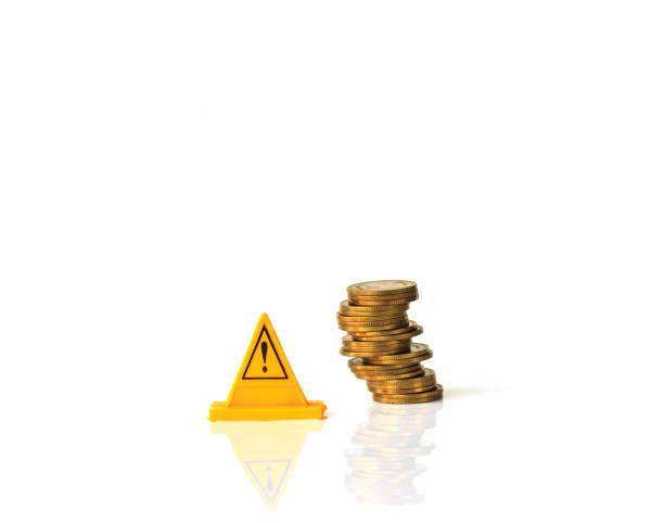 istock Risky coin stack and Warning label on white background.Financial crisis concept. 878310592