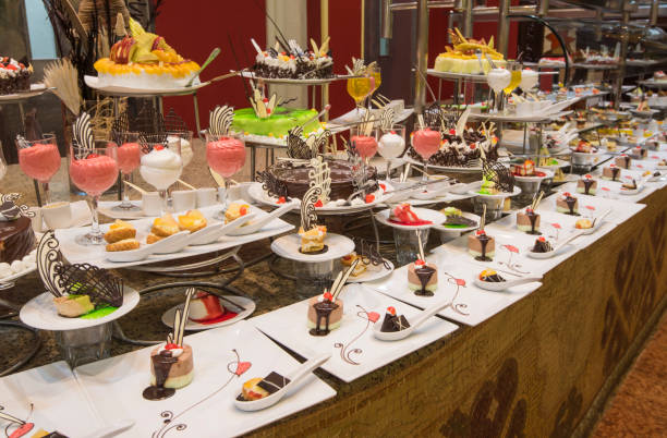 istock Selection of desserts on display at a restaurant buffet 878321756
