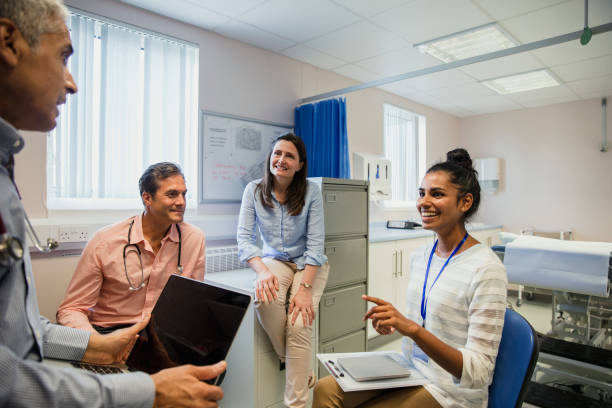 Doctors have a Staff Meeting Doctors have a staff meeting in a medical centre doctor general practitioner stock pictures, royalty-free photos & images