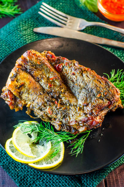 istock Pork meat on ribs baked in an oven 878336684