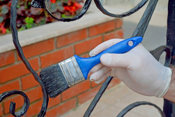 human hand painting metal fence