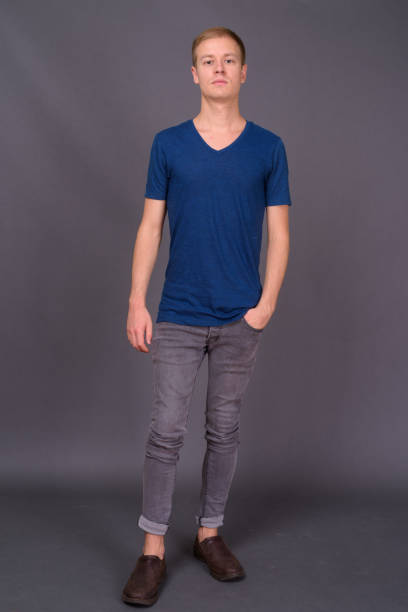 istock Young handsome man with short blond hair against gray background 878350444