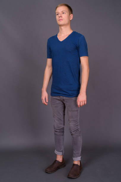 istock Young handsome man with short blond hair against gray background 878350446