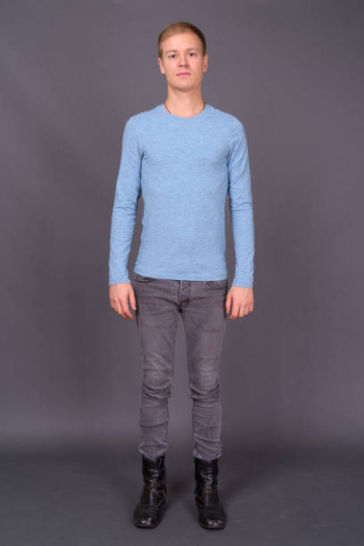 istock Young handsome man with short blond hair against gray background 878361776