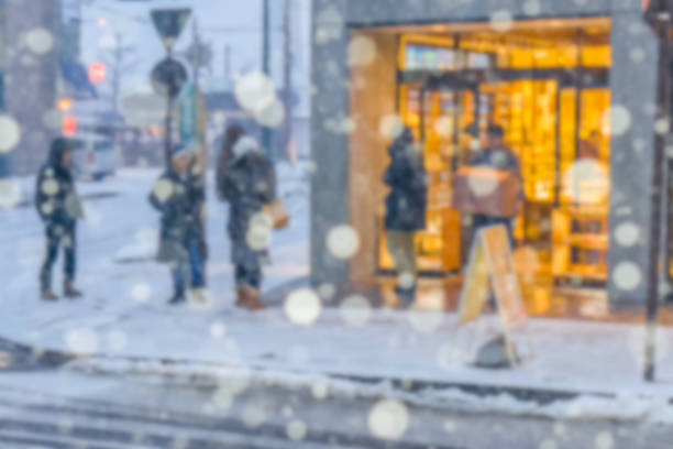 istock blurred background of people shopping among snowing 878365232