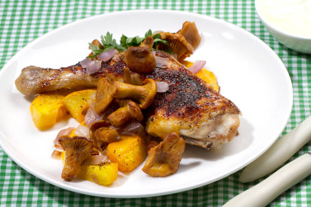 istock Honey glazed chicken leg with pumpkin and wild chanterelles 878367262