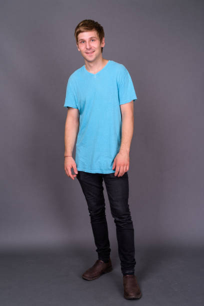 istock Young handsome man wearing blue shirt against gray background 878368986