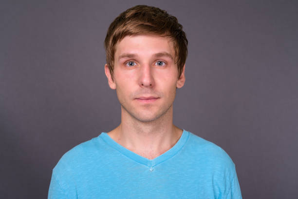 Mid adult man showing that he doesn't know, studio shot, white background