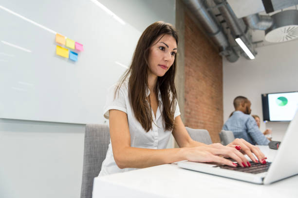 istock Close-up waoman typing on laptop keyboard on desk 878371972