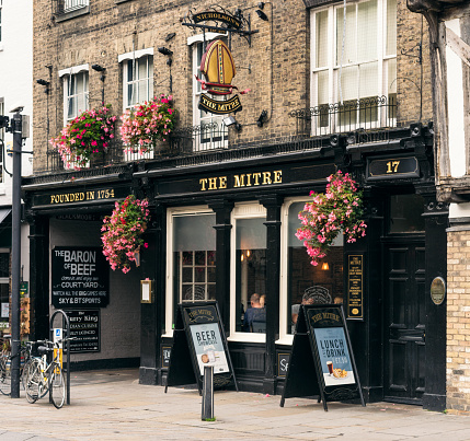 Cambridge, UK - The street facade of the ancient pub The Mitre in central Cambridge.