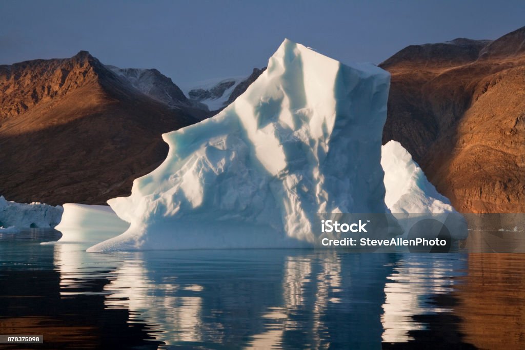 Scoresbysund - Greenland An Iceberg slowly melting in Scoresbysund on the east coast of Greenland. Environment Stock Photo