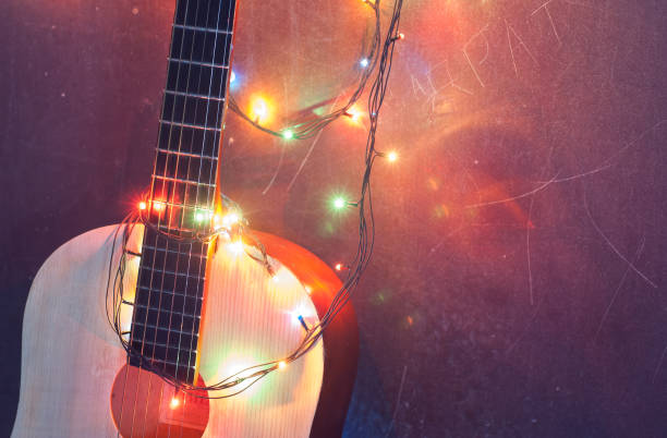 istock Christmas background, an acoustic guitar with a garland, 878384462
