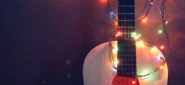 istock Old acoustic guitar with a garland on grunge background, 878384686