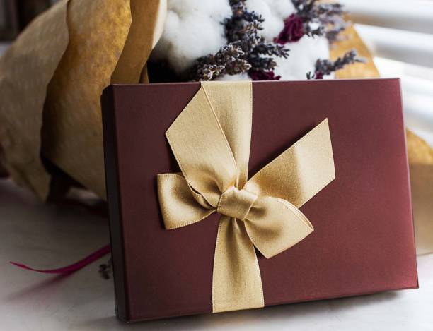 istock Terra cotta present box with gold ribbon 878385144