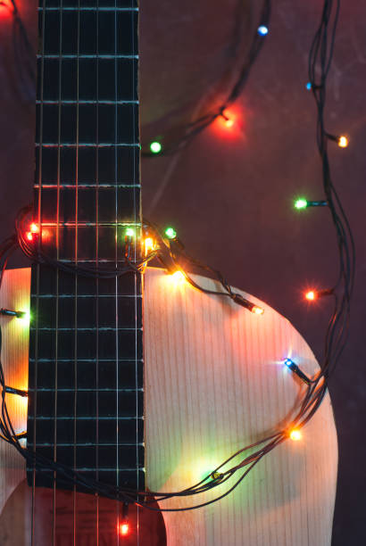 istock Acoustic guitar with lighted garland, 878387184