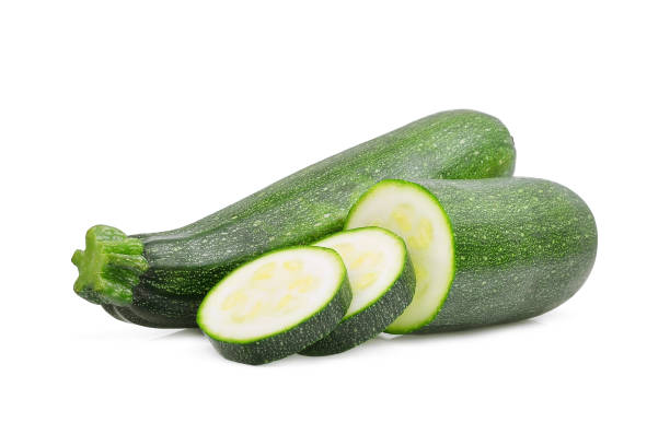 istock fresh green zucchini with slice isolated on white background 878387276