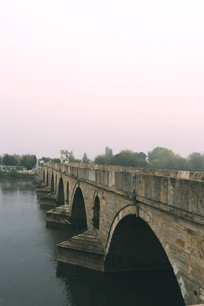 istock Old bridge on Meric  or Evros river in Edirne, Turkey 878390918