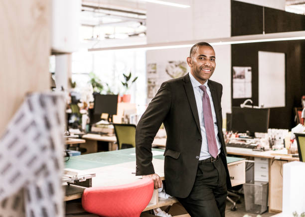 istock Smiling mature businessman in office 878390980