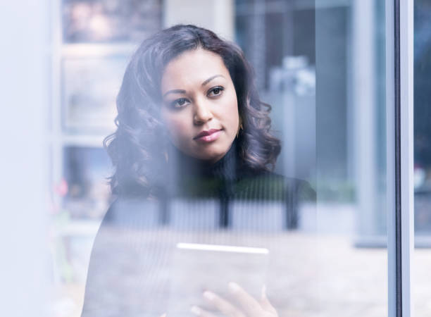 istock Businesswoman holding digital tablet in office 878400918