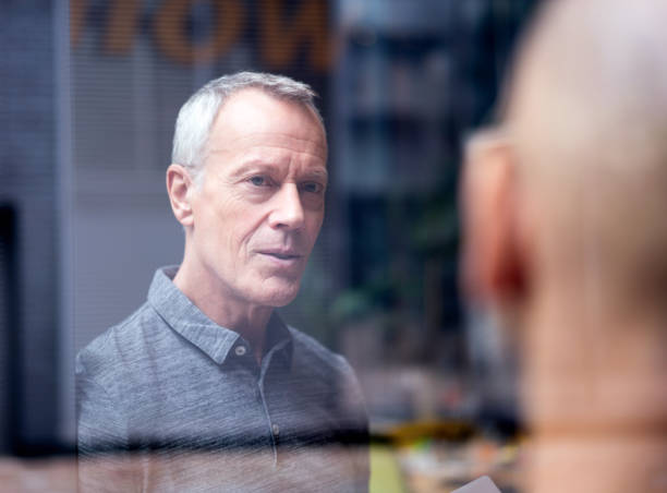 istock Businessman discussing with colleague in office 878401970