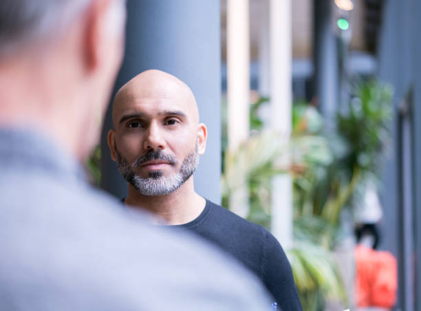 istock Businessman discussing with colleague in office 878402142