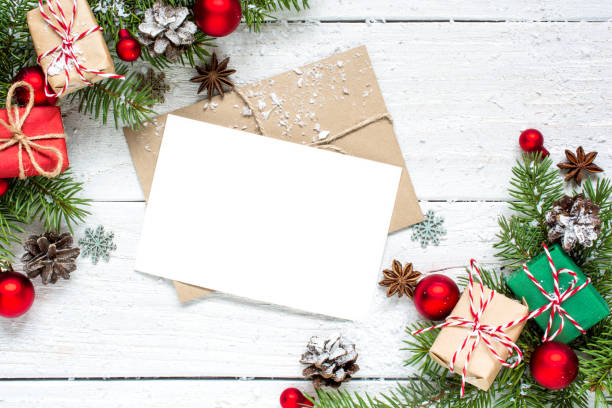 istock christmas greeting card with fir tree branches, decorations and gift boxes over white wooden background 878402462