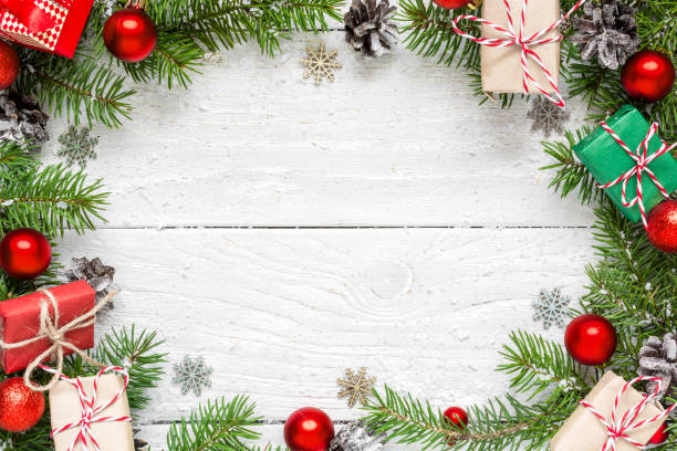 istock Christmas frame made of fir branches, festive decorations, gift boxes and pine cones 878404746