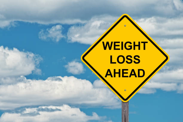istock Caution Sign Blue Sky Background - Weight Loss Ahead 878404960
