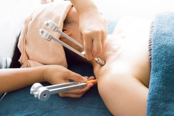 Woman recieving tuning fork therapy