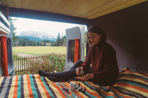 istock Woman spending time in camper van with view on Alps 878410326