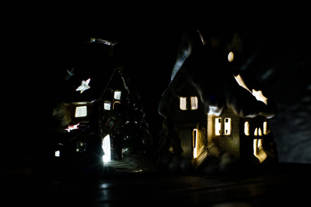 istock Decorative glowing house on a black background. Christmas decorations, a house, snow. 878410394