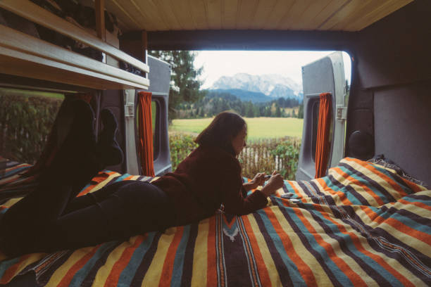 istock Woman spending time in camper van with view on Alps 878414004