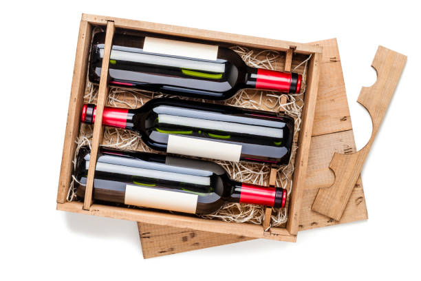 istock Opened wooden box with three red wine bottles inside it isolated on white background 878415386