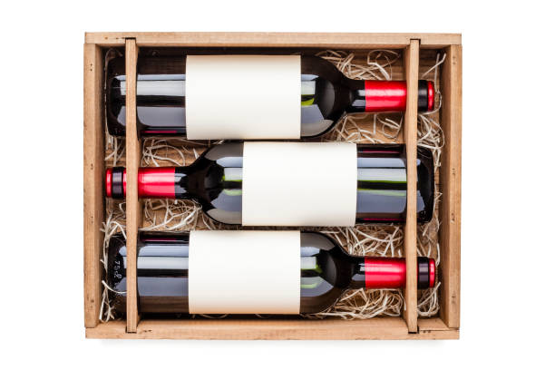 istock Opened wooden box with three red wine bottles inside it isolated on white background 878415424