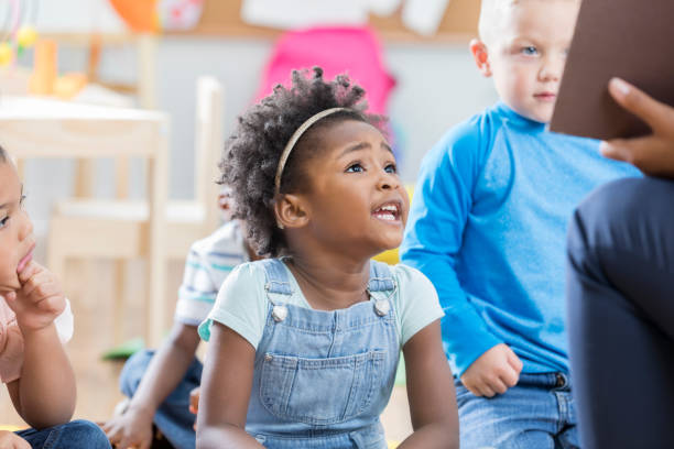 Pretty little girl in front of a row of kids