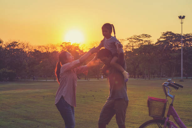 istock Family silhouette with bike, 878418530