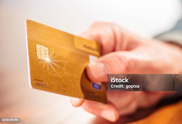 Hand With Golden Credit Card Stock Photo - Download Image Now - Credit Card, Hand, Gold - Metal